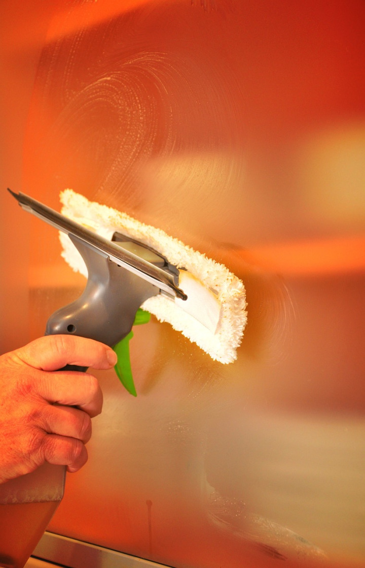 residential window cleaning hand wiping glass